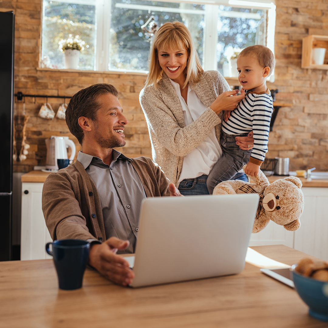 Daddy, come to play with us Dad is working online while mom and son is playing beside