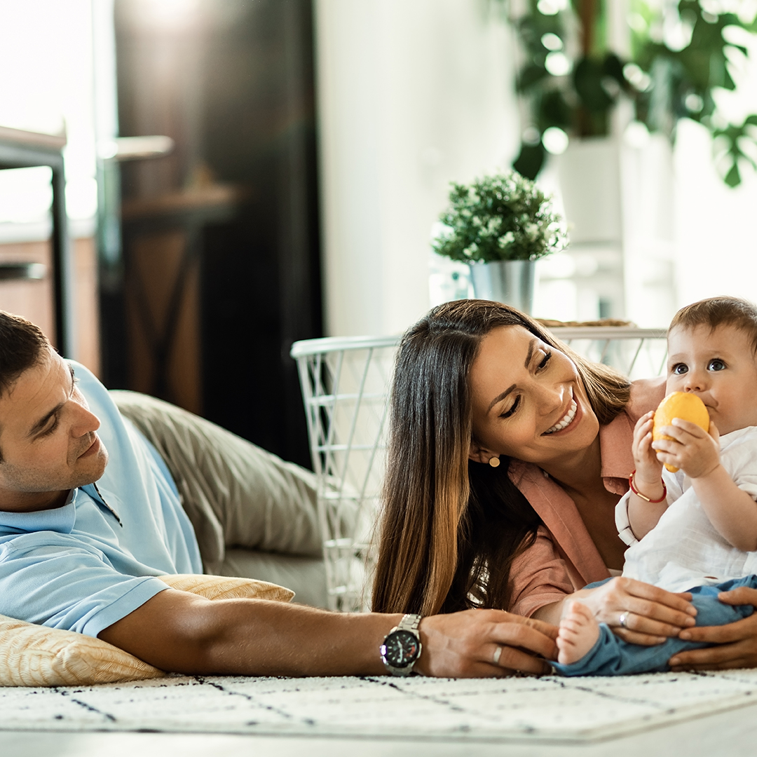 Happy family spending time together at home. Happy parents enjoying in their time with their small son at home.